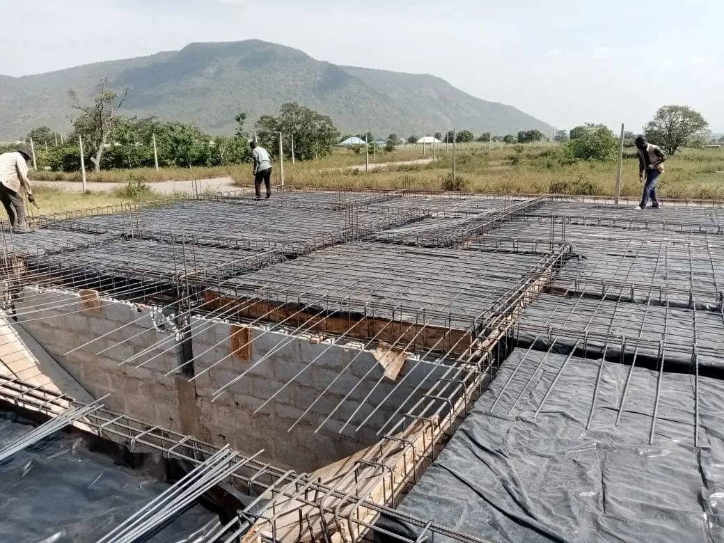 Raft foundation: reinforcement mesh laid over a polythene membrane, hills in the distance