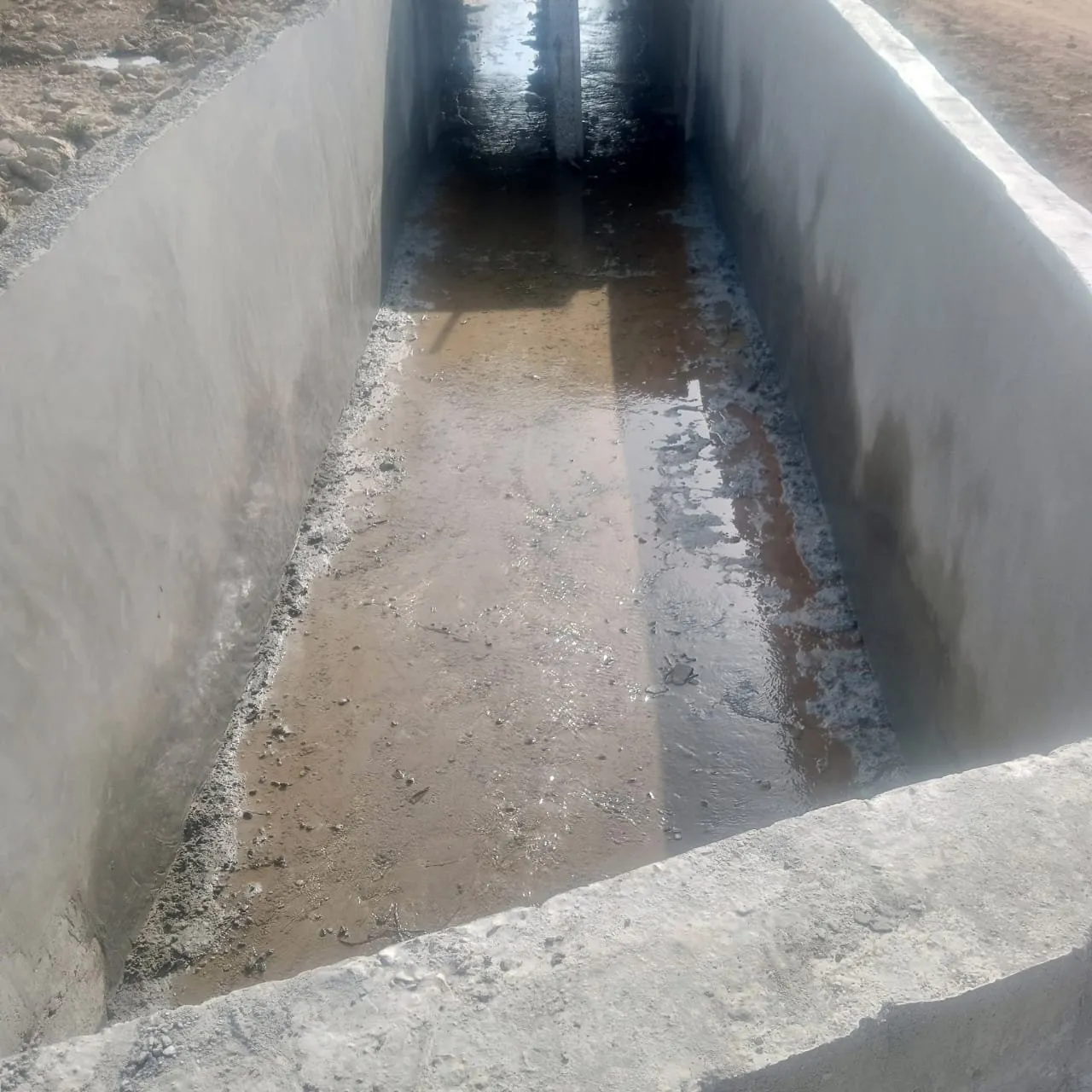 View along a finished concrete drainage channel