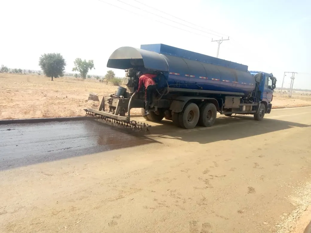 Bitumen distributor truck spraying a prime coat on the prepared road base