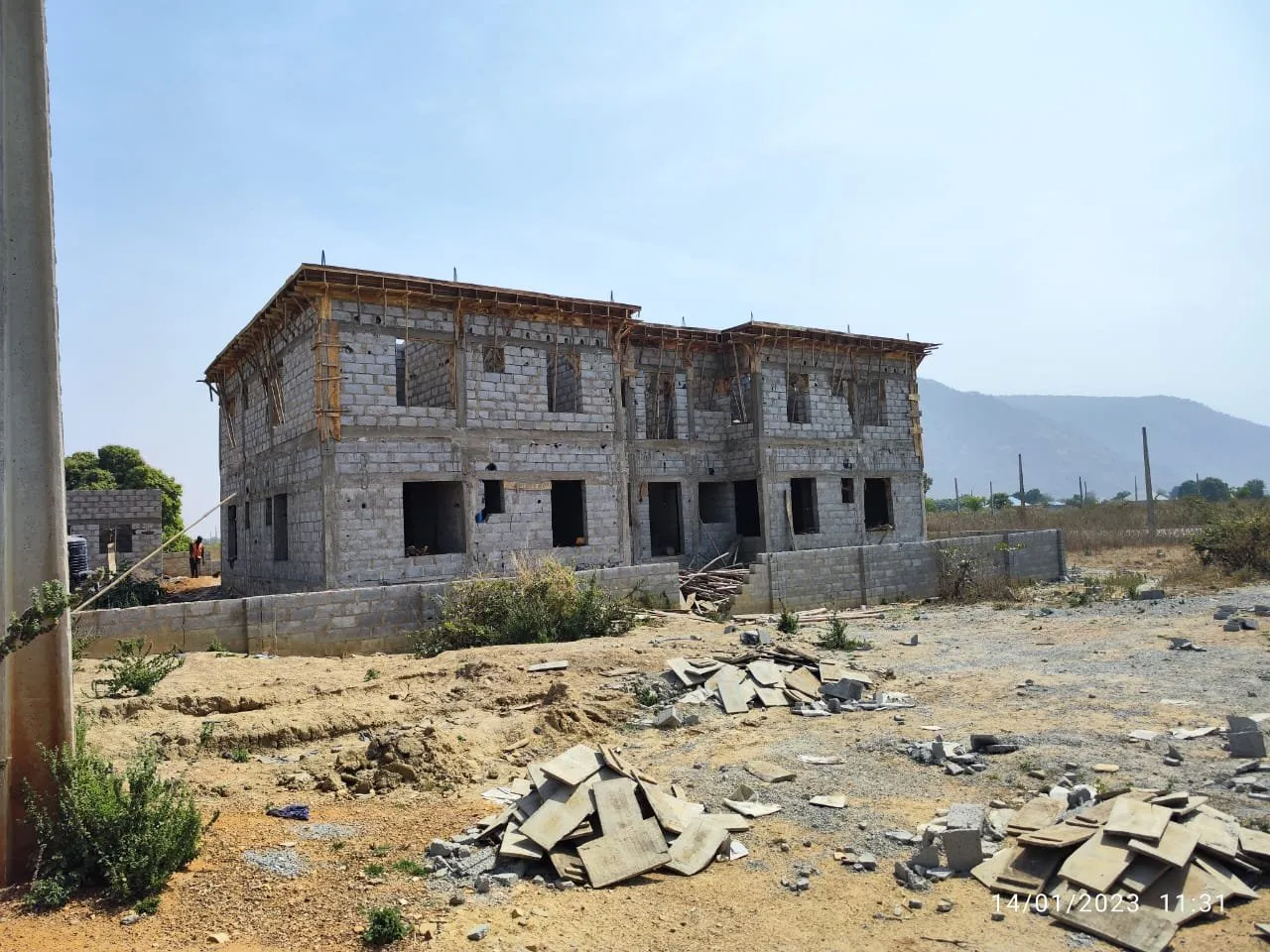 Completed two-storey blockwork shell of a residential building on a cleared site