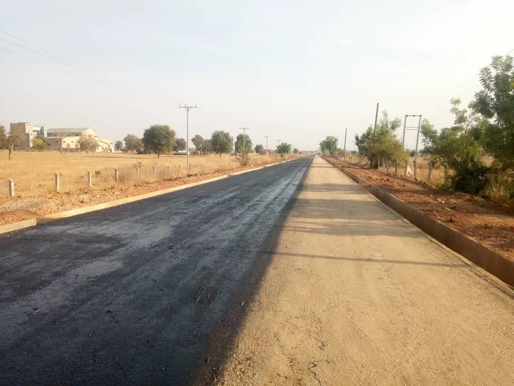 New asphalt surface beside the unsurfaced road base